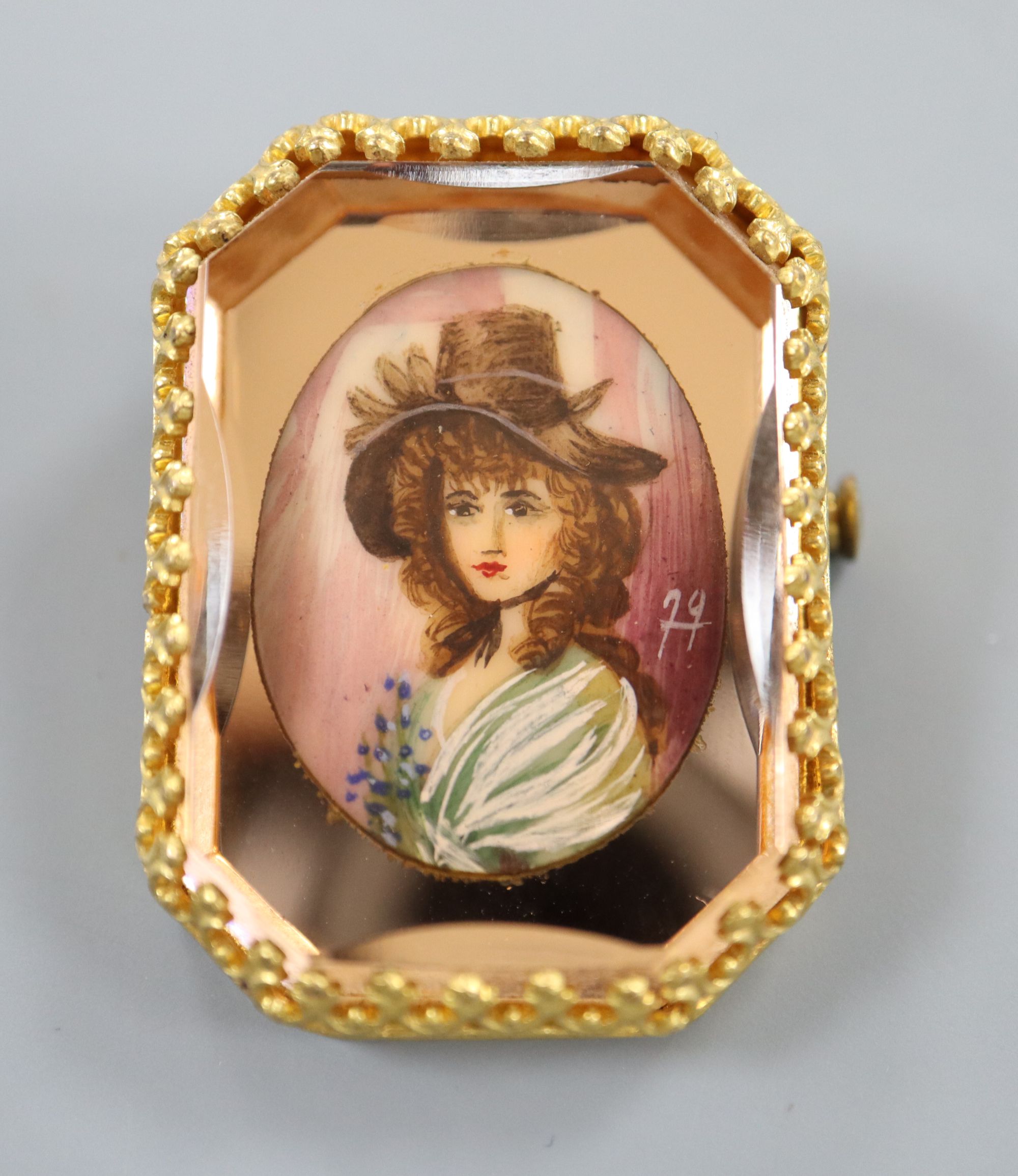 A yellow metal mounted octagonal brooch, with oval painted bust of a lady in mirrored surround, 36mm, gross 16.8 grams.